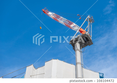 Construction site and crane under blue sky Construction site and crane under blue sky 108104472