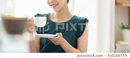 woman drinking coffee in the living room woman drinking coffee in the living room 108106553