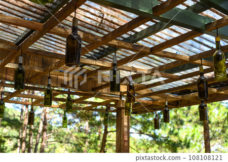 Decor for bulbs and lighting as glass bottles hanging under roof Decor for bulbs and lighting as glass bottles hanging under roof 108108121