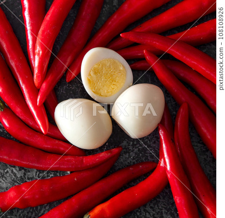 Chili pepper, egg and pasta on an isolated white 108108926