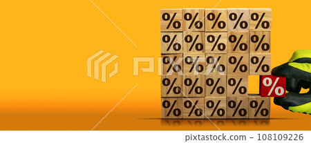 Gloved Hand Chooses a Wooden Block with Percentage Sign 108109226
