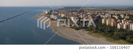 Aerial shot of sandy beach with umbrellas and Lido Adriano town Aerial shot of sandy beach with umbrellas and Lido Adriano town 108110407