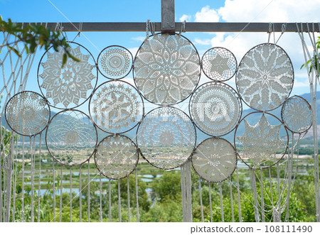 Examples of various knots of macrame technique made of white threads 108111490