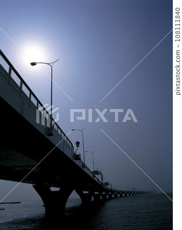 Bridge over the sea, outdoor lights, sun and blue sky Bridge over the sea, outdoor lights, sun and blue sky 108111840