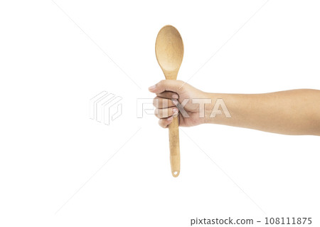 Human hand holding wooden spoon Human hand holding wooden spoon 108111875