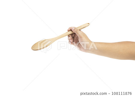 Human hand holding wooden spoon 108111876