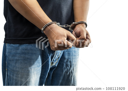 Arrested man with a handcuff on his hand Arrested man with a handcuff on his hand 108111920