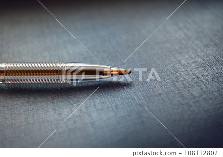 Ballpoint pen perpendicular on a gray background Ballpoint pen perpendicular on a gray background 108112802
