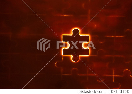 Pieces of a jigsaw puzzle filled with orange lights by hand Success concept 108113108