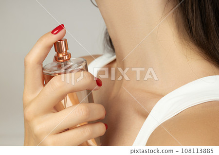 Beautiful bottle with perfume in hand close-up 108113885