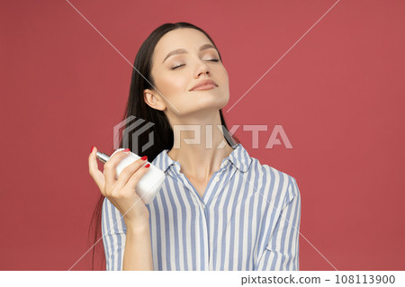 Attractive girl in a shirt with perfume in her hand Attractive girl in a shirt with perfume in her hand 108113900