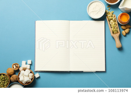 Ingredients and a blank notebook for writing down recipes. 108113974
