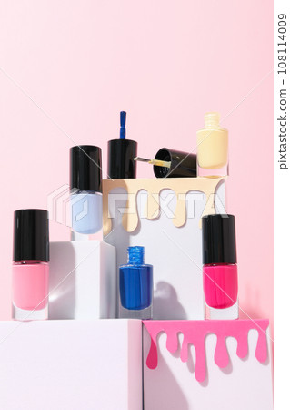 Pink nail polish with white cubes on a light background 108114009