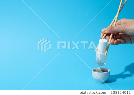 White nail polish with chopsticks for sushi and a bowl 108114011
