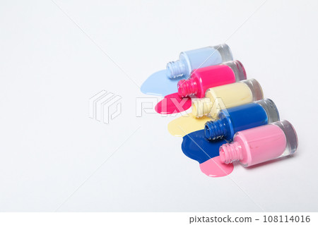 Multicolored open nail polishes on a white background 108114016