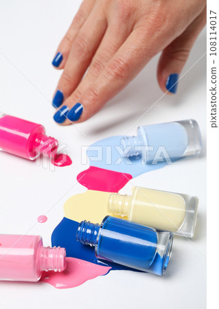 Multicolored open nail polishes on a white background Multicolored open nail polishes on a white background 108114017