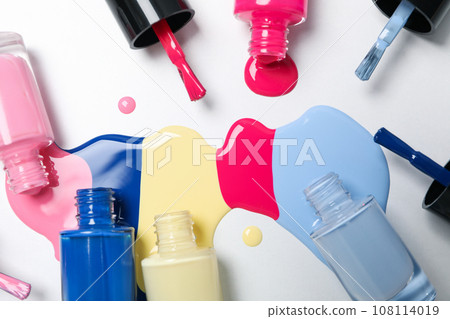 Multicolored open nail polishes on a white background 108114019