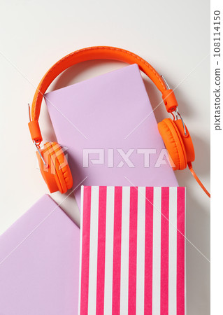 Headphones on books on white background, top view Headphones on books on white background, top view 108114150