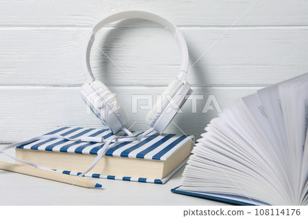 Headphones, books and pencil on white wooden background Headphones, books and pencil on white wooden background 108114176