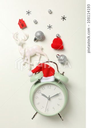 A clock with a Santa hat with a New Year's decoration. A clock with a Santa hat with a New Year's decoration. 108114193