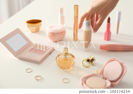 Cosmetics and accessories on a white table 108114234