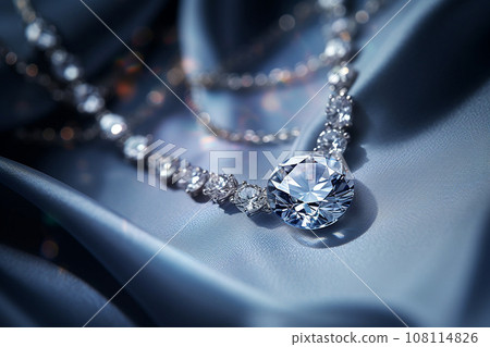 Luxury jewelry, platinum necklace with diamonds on dark silk fabric close-up. Golden necklace in the store. Beautiful diamond pendant necklace. Jewelry showcase, selective focus 108114826