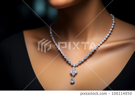 Woman wearing luxury jewelry, platinum necklace with diamonds close-up. Golden necklace on female neck. Beautiful diamond pendant necklace. Beauty, people and jewelry concept Woman wearing luxury jewelry, platinum necklace with diamonds close-up. Golden necklace on female neck. Beautiful diamond pendant necklace. Beauty, people and jewelry concept 108114850