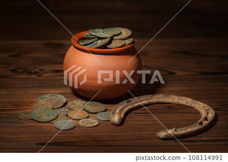 St Patricks day concept with pot with old coins 108114991