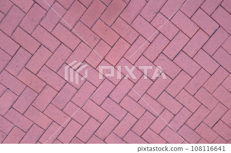 Paving slabs laid out in shape of herringbone on city street background Paving slabs laid out in shape of herringbone on city street background 108116641