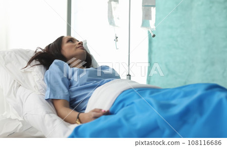Closeup of young woman laying in hospital bed and waiting 108116686