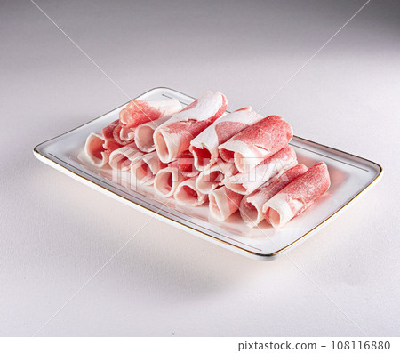 fresh and aesthethic bacon rolls on a white plate. View from above. Chinese cuisine, ingredient for hotpot fresh and aesthethic bacon rolls on a white plate. View from above. Chinese cuisine, ingredient for hotpot 108116880
