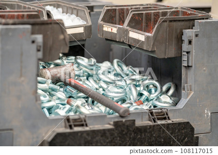 hammer and screws in a crate at the factory hammer and screws in a crate at the factory 108117015