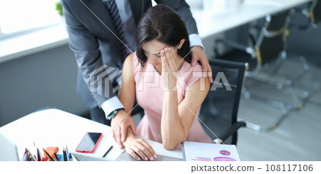 Businessman pestering female colleague in the workplace. 108117106