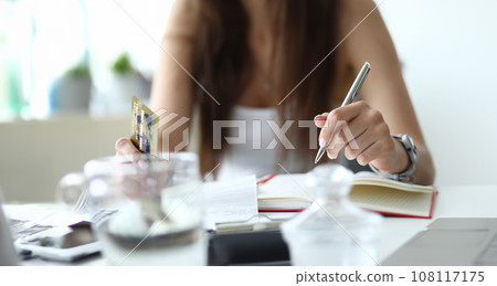 Focus on tender businesswoman arms writing with metallic pen 108117175