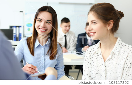 Portrait of gorgeous woman sitting in big modern building and talk about new business strategy 108117202