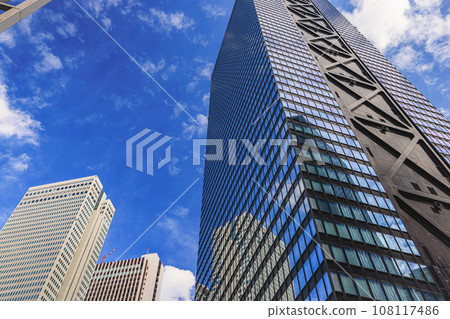 A skyscraper rising in the blue sky A skyscraper rising in the blue sky 108117486