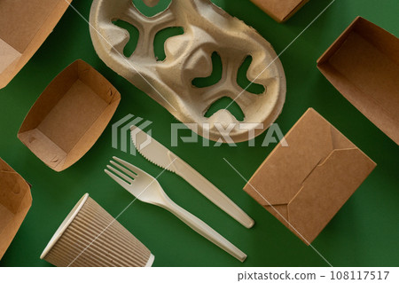 Packaging concept - selection of paper craft packaging on green background Packaging concept - selection of paper craft packaging on green background 108117517