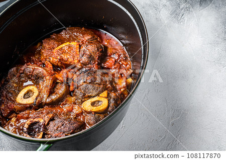 Osso buco cross cut veal shank braised with tomatoes and spices, beef meat Ossobuco. White background. Top view. Copy space Osso buco cross cut veal shank braised with tomatoes and spices, beef meat Ossobuco. White background. Top view. Copy space 108117870