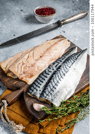 Cooking of fresh raw mackerel fillet fish on a cutting board. Gray background. Top view Cooking of fresh raw mackerel fillet fish on a cutting board. Gray background. Top view 108117944