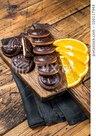 Chocolate Jaffa Cakes with Orange Flavored Marmalade. Wooden background. Top view 108117948