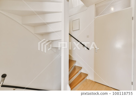 an empty staircase in a house with wood floors and white walls, as seen from the top down to the bottom an empty staircase in a house with wood floors and white walls, as seen from the top down to the bottom 108118755
