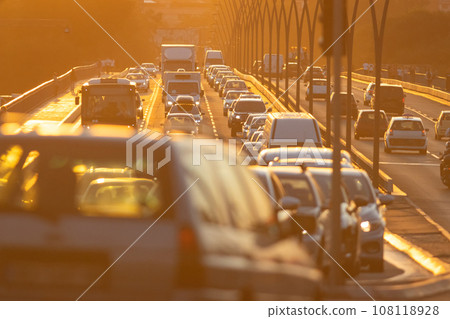 Busy street with many cars on sunset Busy street with many cars on sunset 108118928