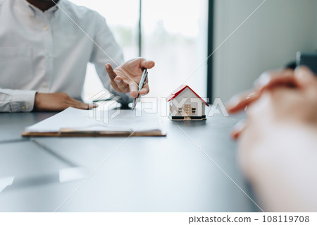 Guarantee, mortgage, agreement, contract, signed, real estate agent pointing to documents for customers to read the agreement before signing important documents. 108119708