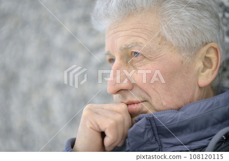 Portrait of a beautiful elderly pensive man 108120115