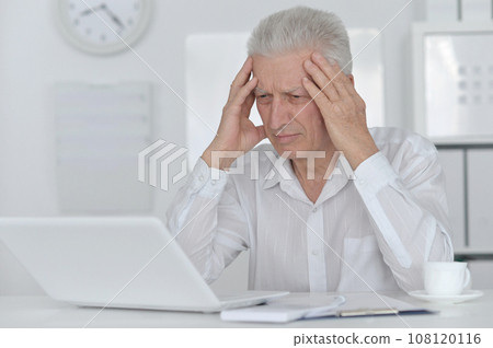Senior businessman working with his laptop at office Senior businessman working with his laptop at office 108120116
