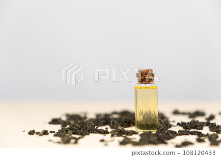 Green tea oil in a glass bottle for use in cosmetology and aromatherapy. Green tea oil in a glass bottle for use in cosmetology and aromatherapy. 108120433