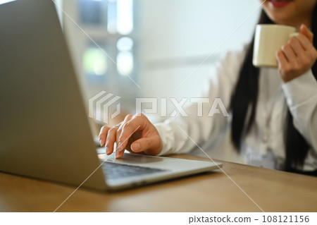 Female investment advisor chatting with client online, communicating on internet via laptop computer 108121156