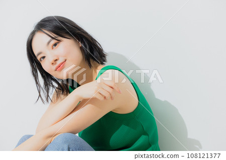 Woman in green tank top Woman in green tank top 108121377