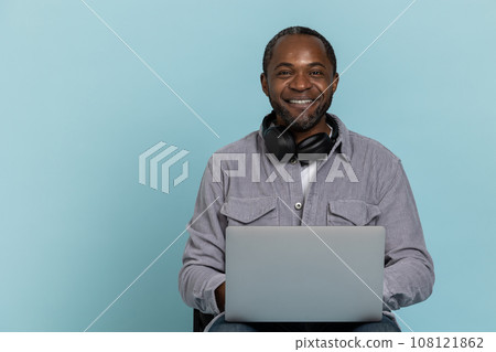 Cheerful guy working on laptop remote job. 108121862