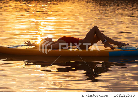 Beautiful woman with perfect body lying on the supboard. Beautiful woman with perfect body lying on the supboard. 108122559